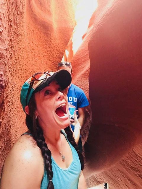 RN, Amanda M., squeezing through a tight space in Antelope Canyon near Page, Ariz.