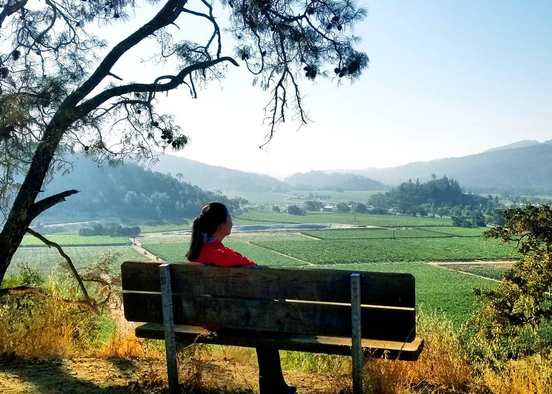 RN, May D., sitting on a bench along the Oat Hill Mine Trail in Cali.